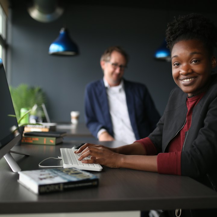 Two colleagues working together at a shared desk