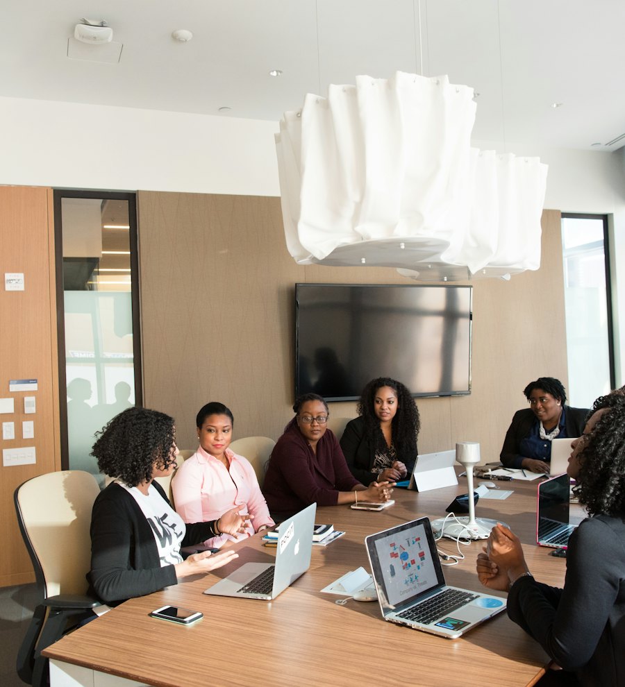 A team working through a project around a meeting-room table